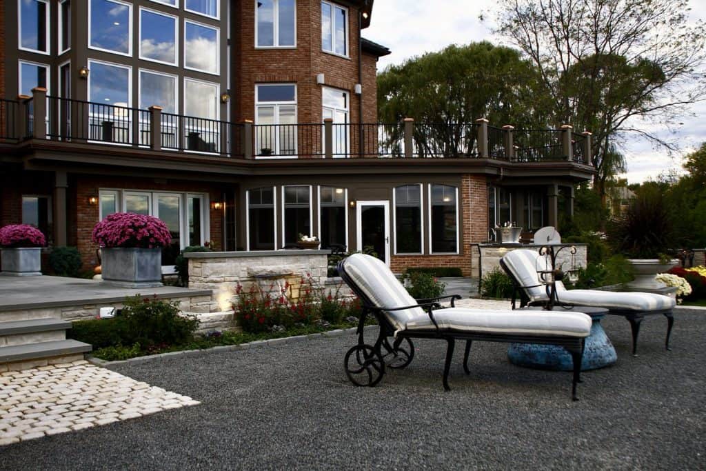 Crushed bluestone seating area with a custom waterfall feature in Barrington, IL | Milieu Landscaping