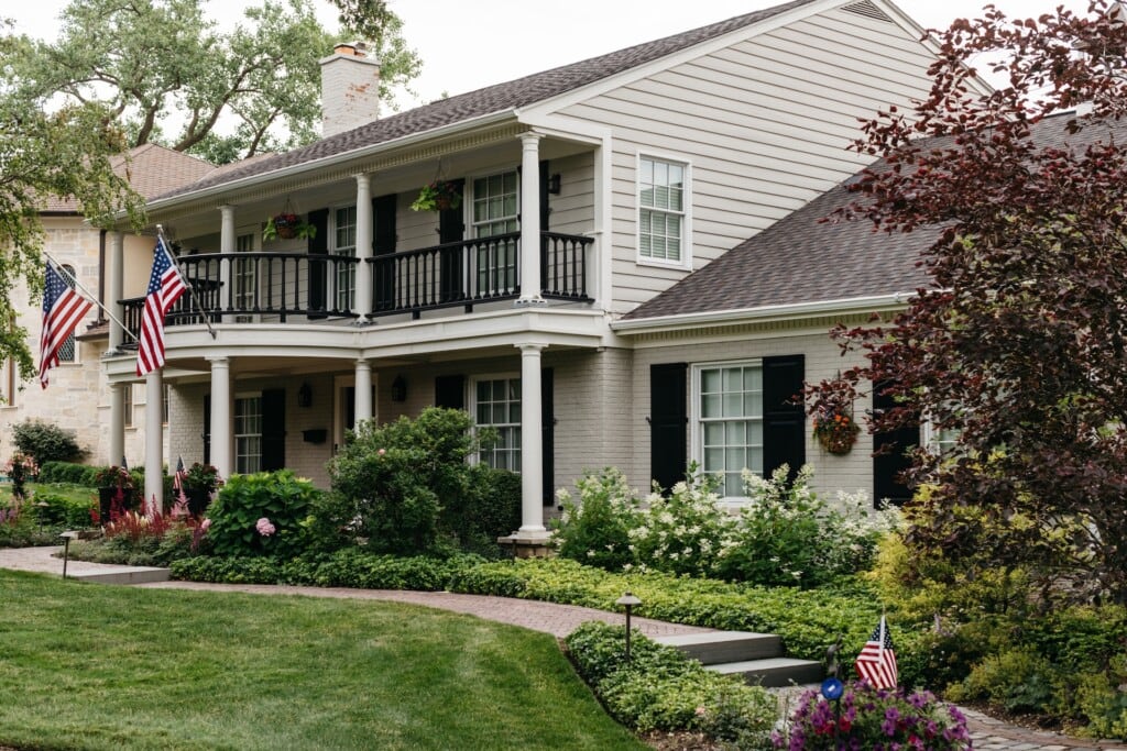 Paver walkway hardscaping with natural stone steps up to front entry in Northbrook, IL | Milieu Landscaping