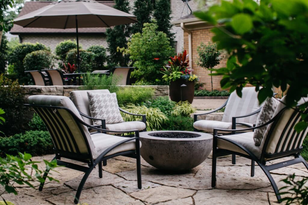 Custom fire bowl feature with seating on a natural stone patio in Northbrook, IL | Milieu Landscaping
