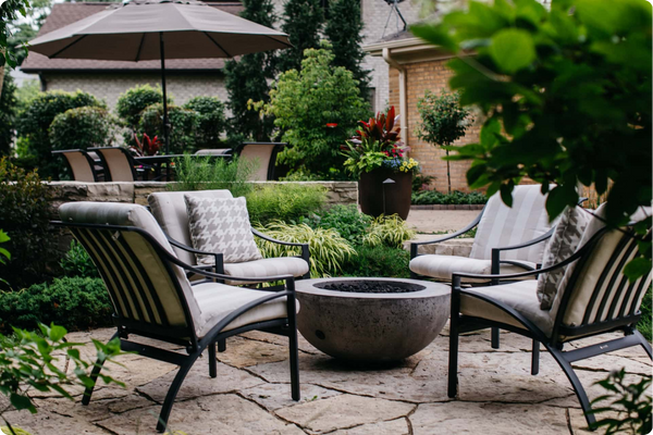 Custom fire bowl feature with seating on a natural stone patio in Northbrook, IL