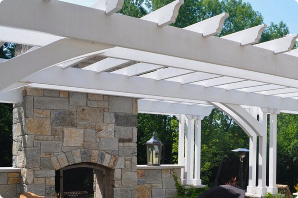 custom outdoor fireplace with white pergola