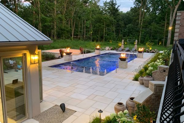 Beautiful backyard design with pool, cabana, fire features, lighting