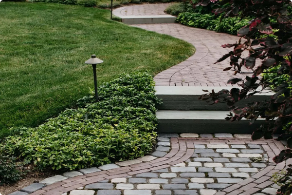 Image of a landscape design with a path and lighting